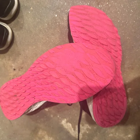 Worn Black Sneakers with Pink Soles